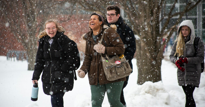 Central College students walking across campus while it snows.