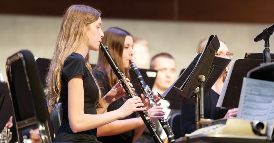 Central College students playing clarinet in the band.