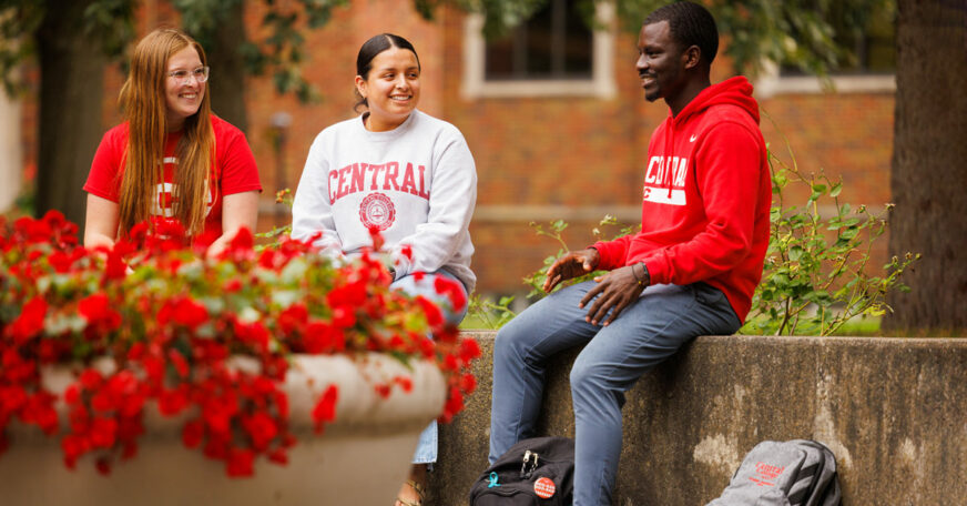 Three Central College students sitting near the Peace Mall, the heart of campus.