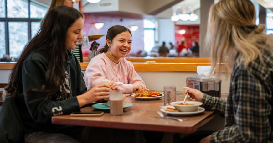 Students eating together atat Central Market, the flagship dining facility on campus.