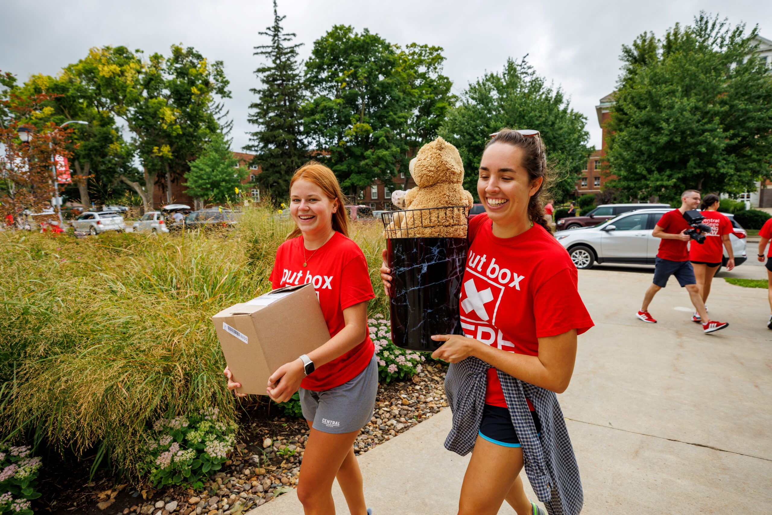 Central students carrying boxes on move in day.