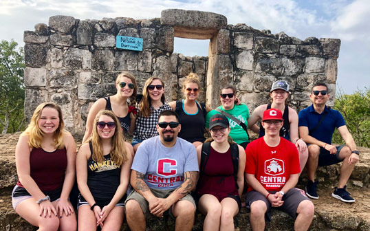 Senior lecturer of Spanish Oscar Reynaga and Central students pose for a group photo while abroad.